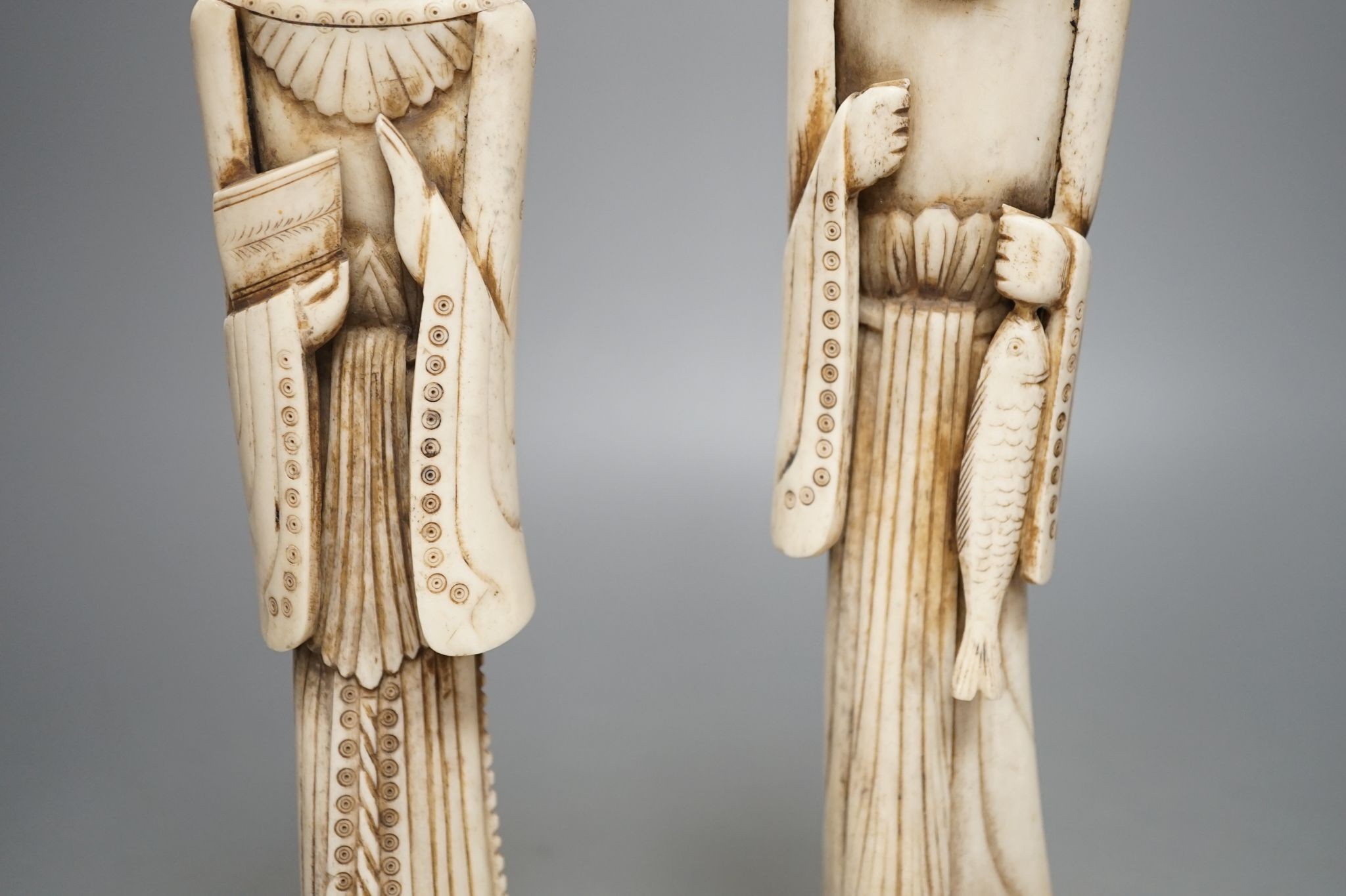 A pair of Chinese carved bone figures, Tallest 27 cms high.